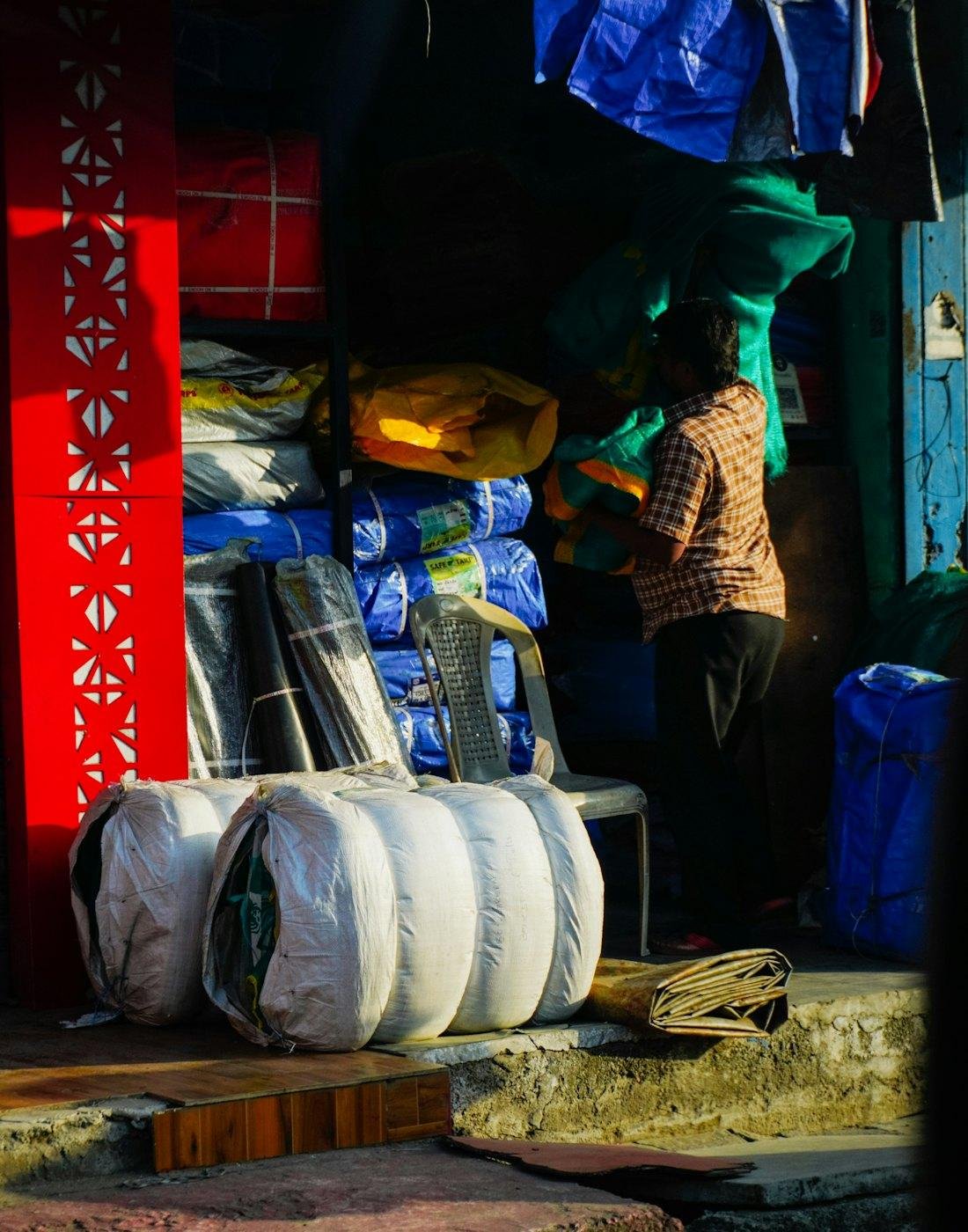 Stacked tarpaulin rolls in a shop